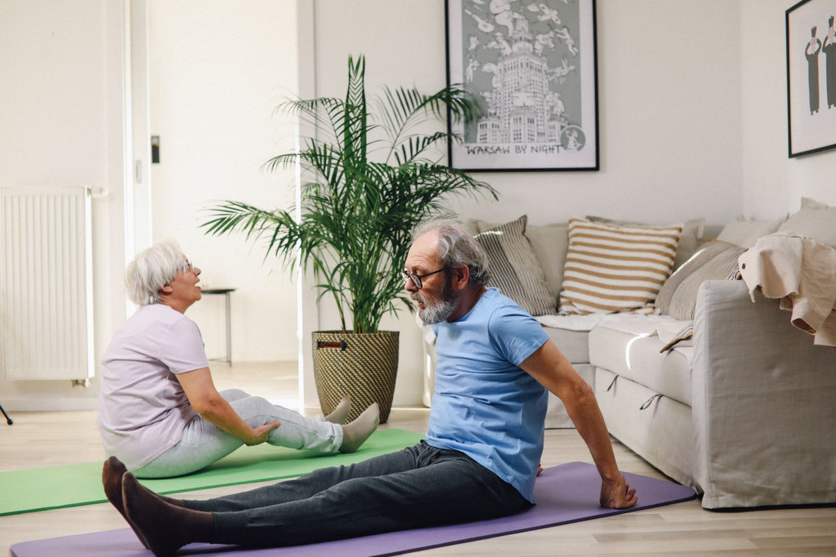 Couple stretching at home to ease stiffness