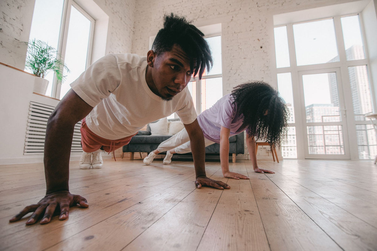 Couple doing push-ups at home